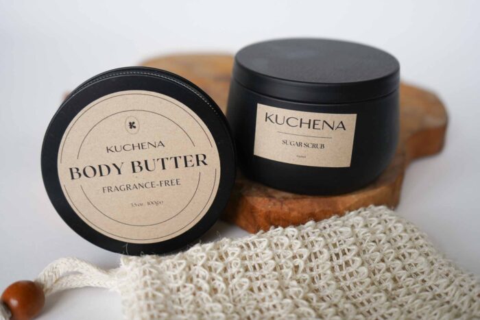 Body Butter Fragrance Free and Sugar Scrub matched together 2 cans. one with body butter and one with body scrub pictured on a piece of wood
